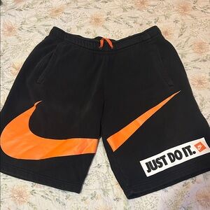 Nike Black Shorts with Orange Swoosh and Just Do It Graphic